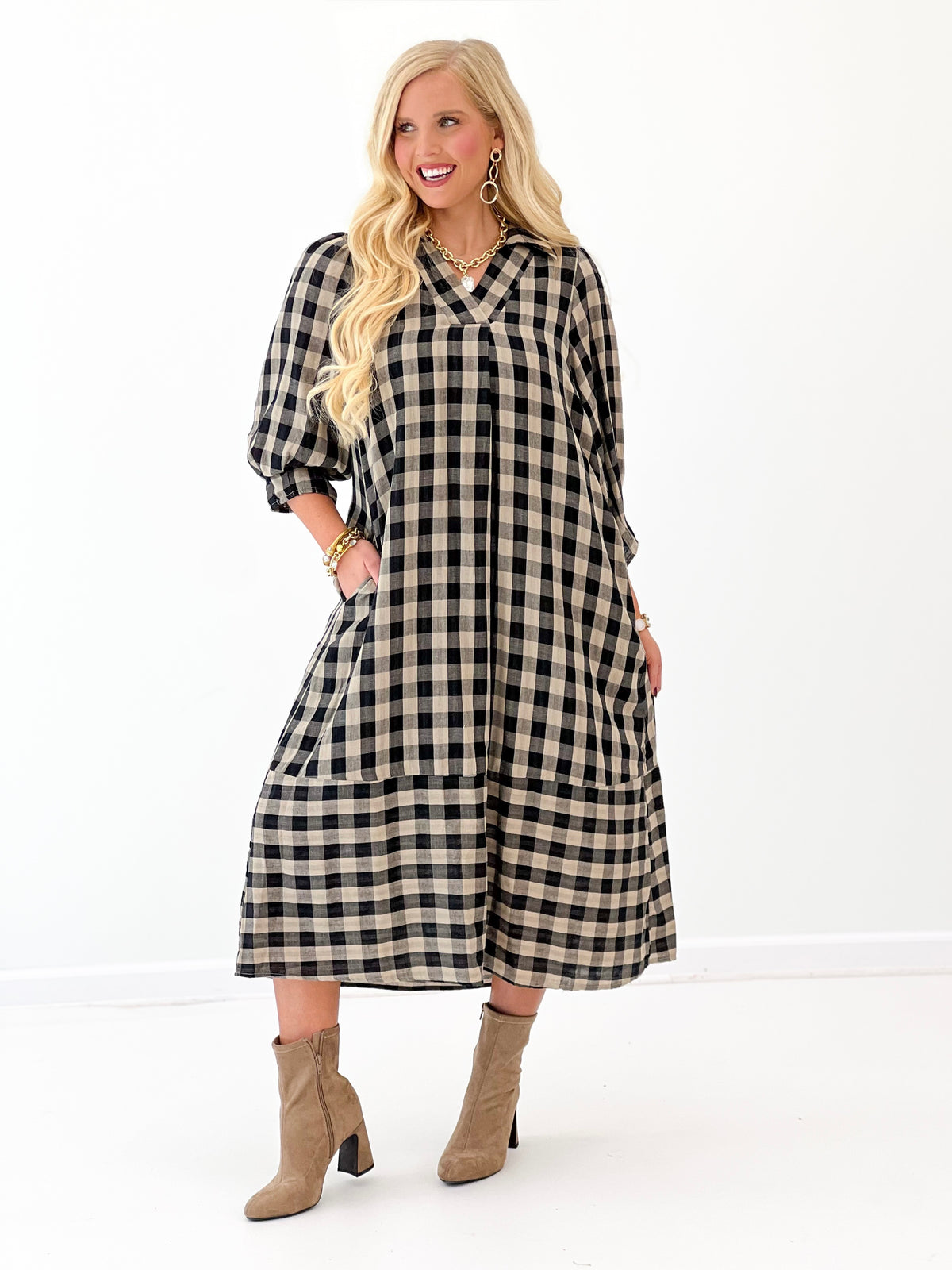 Black-and-white checkered midi dress with open collar and loose three-quarter sleeves