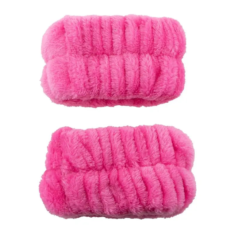 Two hot pink plush spa wristbands with gathered elastic texture