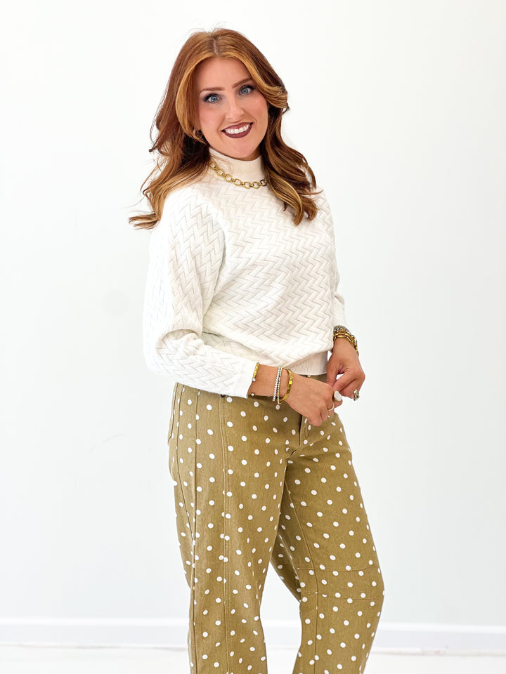 White mock neck sweater with textured zigzag knit and relaxed dolman fit