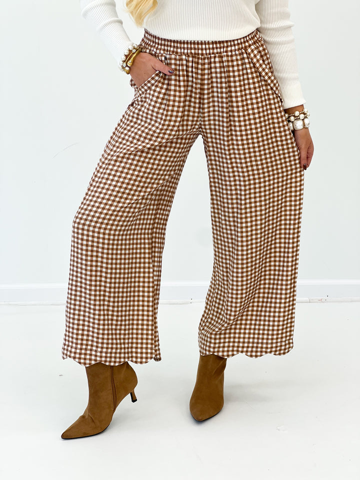 Red and white checkered wide-leg pants, close view of smocked waistband and wide leg