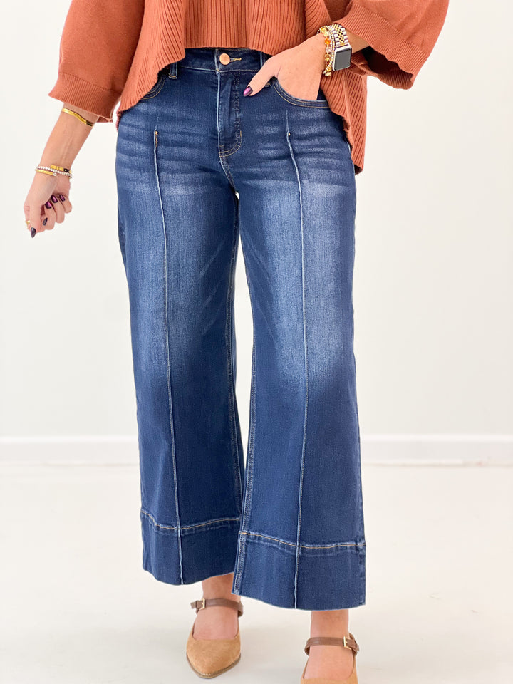 Mid-rise wide-leg crop jeans in blue wash with pintuck front, front buttons, cuffed hem