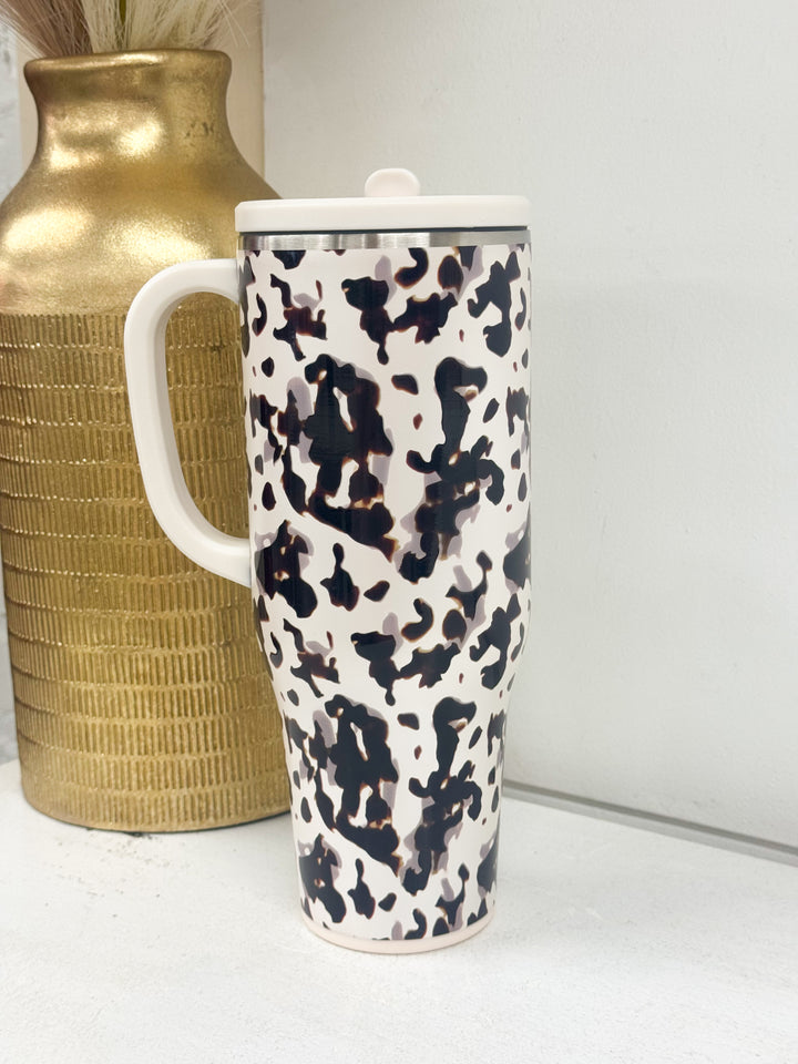 Swig 40oz mega mug with cow print, white handle and flip-top lid