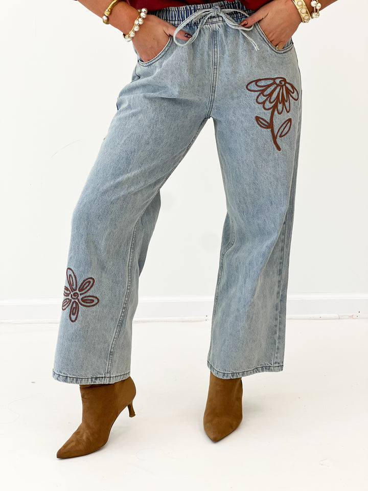 Denim wide-leg jeans with floral embroidery on thigh and stitched back yoke