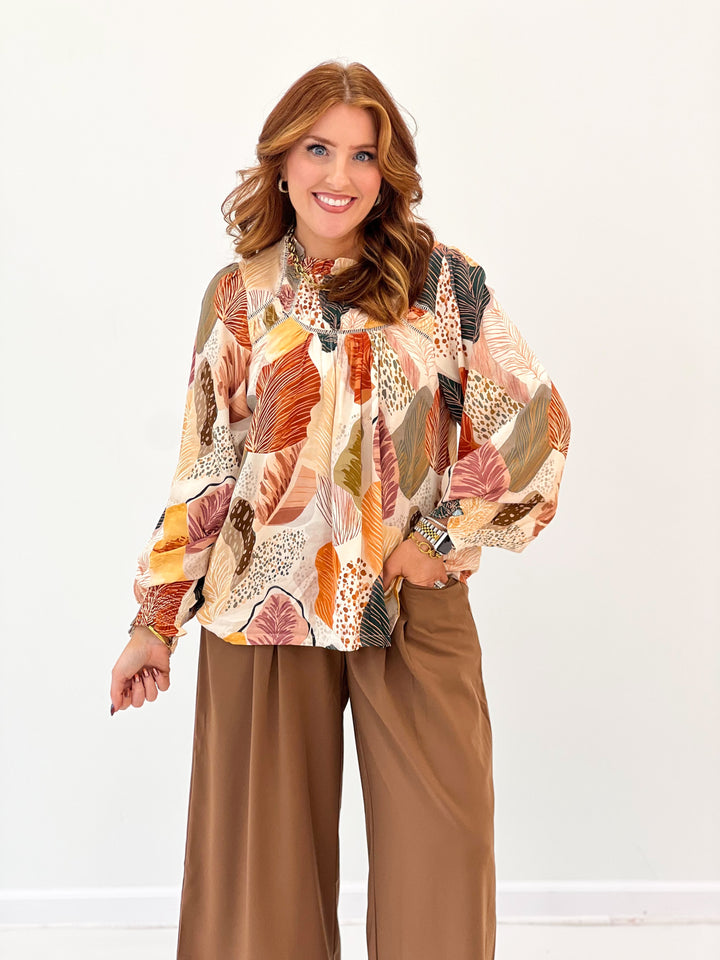 Leaf-print ruffle-trim blouse with long sleeves; multicolor fall tones