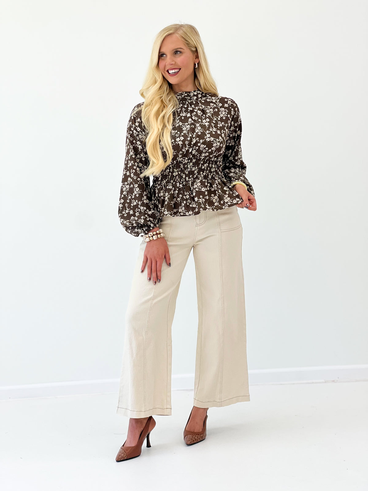 Brown floral printed mock-neck blouse with long sleeves and gathered waist