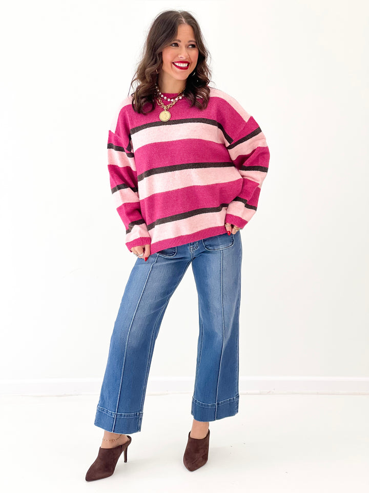 Magenta striped knit sweater top with black and light pink bands, relaxed fit, crew neck