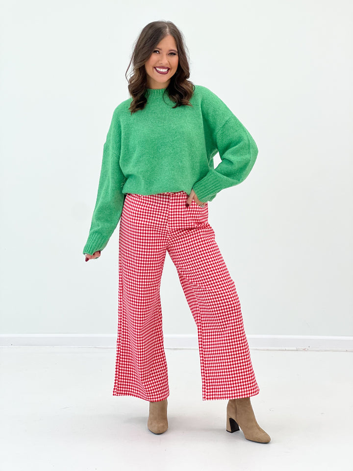 Green ribbed crew neck sweater, cozy knit texture and ribbed hemline
