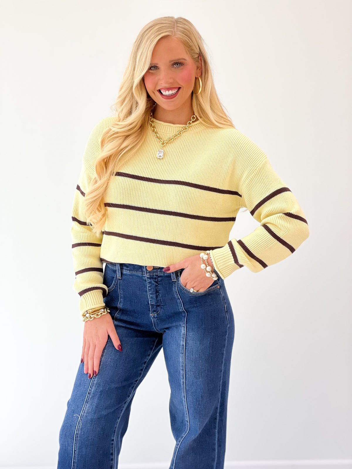 Buttery yellow striped crew neck long sleeve sweater with dark horizontal bands