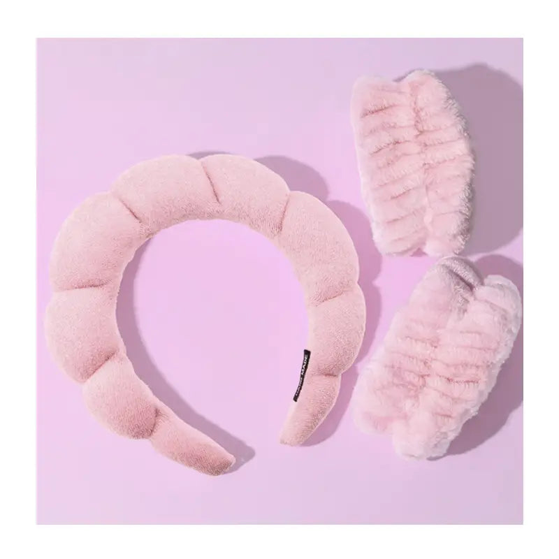 CALA pink spa headband and two plush wristbands with soft gathered fabric.