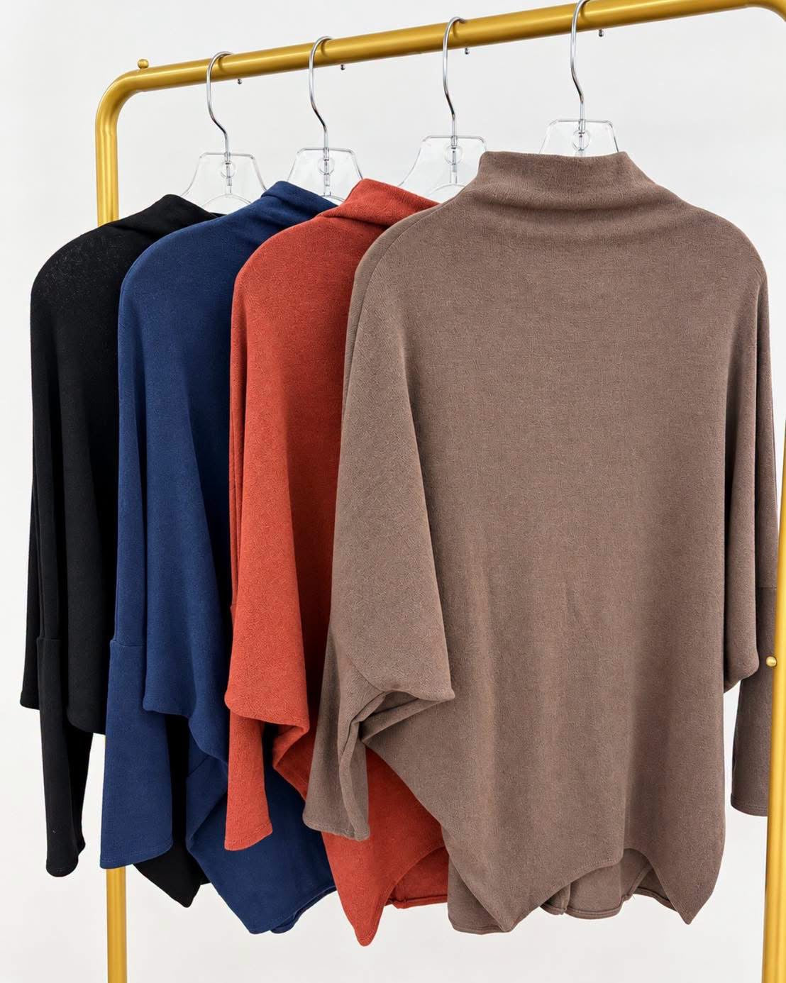 Taupe mockneck dolman top with long sleeves and draped fit on a hanger