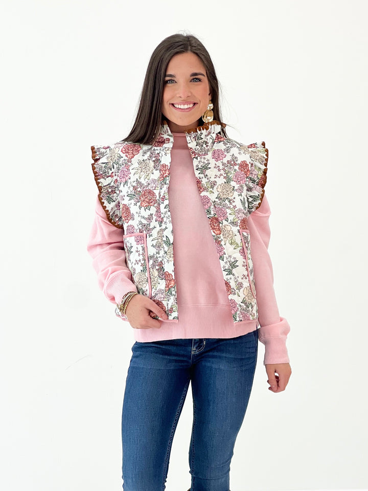 Cream floral ruffle sleeve vest with colorful panels and scalloped ruffle trim