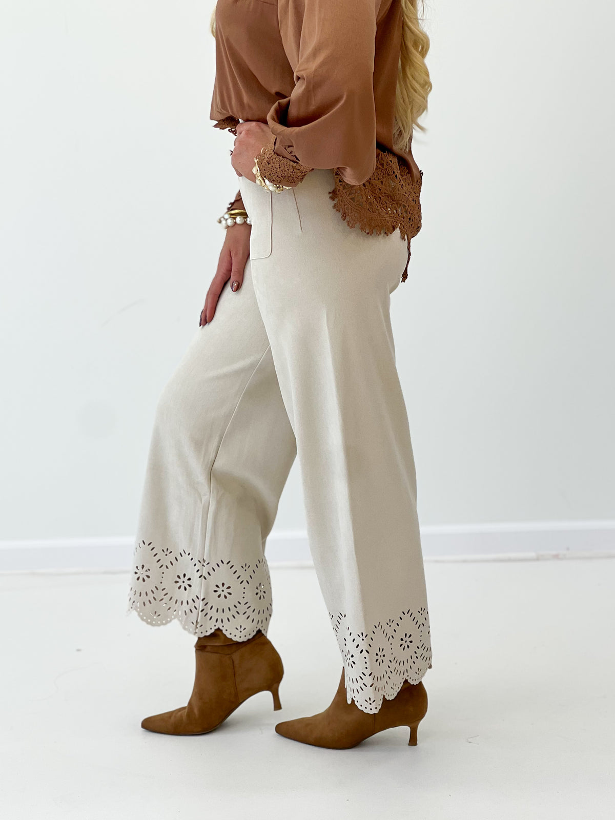 Bone suede wide-leg pants with laser-cut hem edging and scalloped pocket yoke