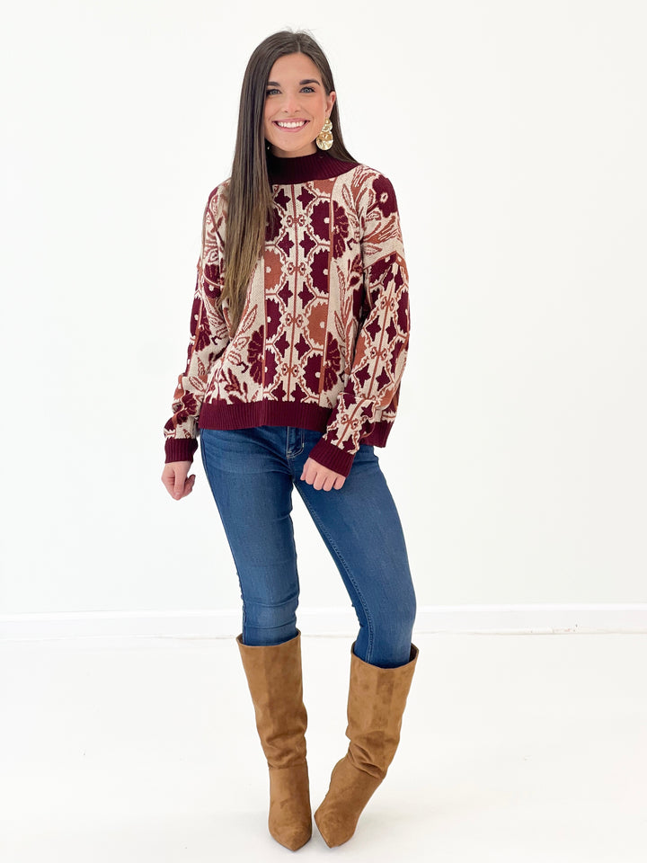 Wine knit sweater with ornate floral tapestry print, crew neck, ribbed cuffs and hem