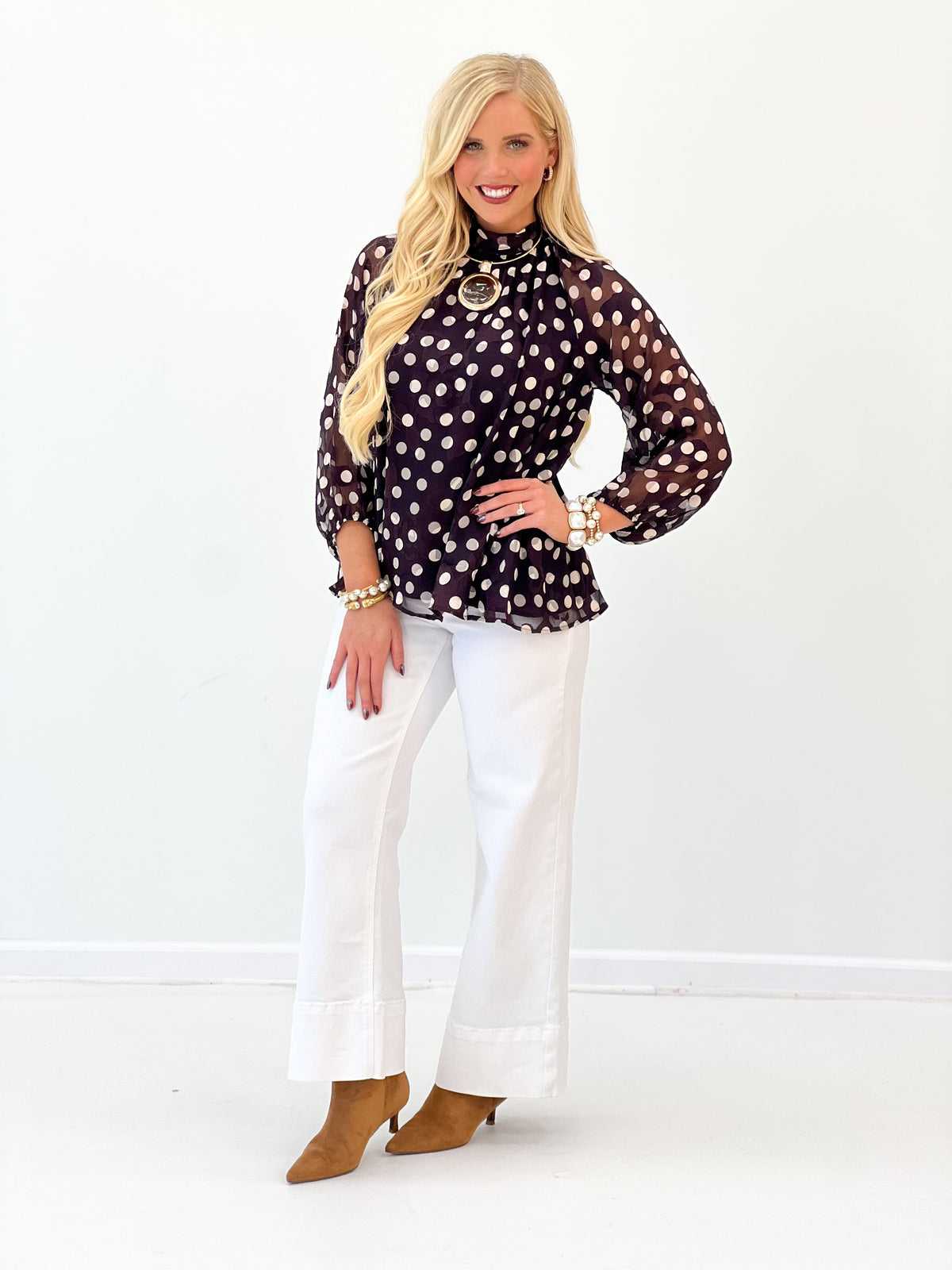 Black polka dot high-neck long-sleeve blouse with keyhole front detail