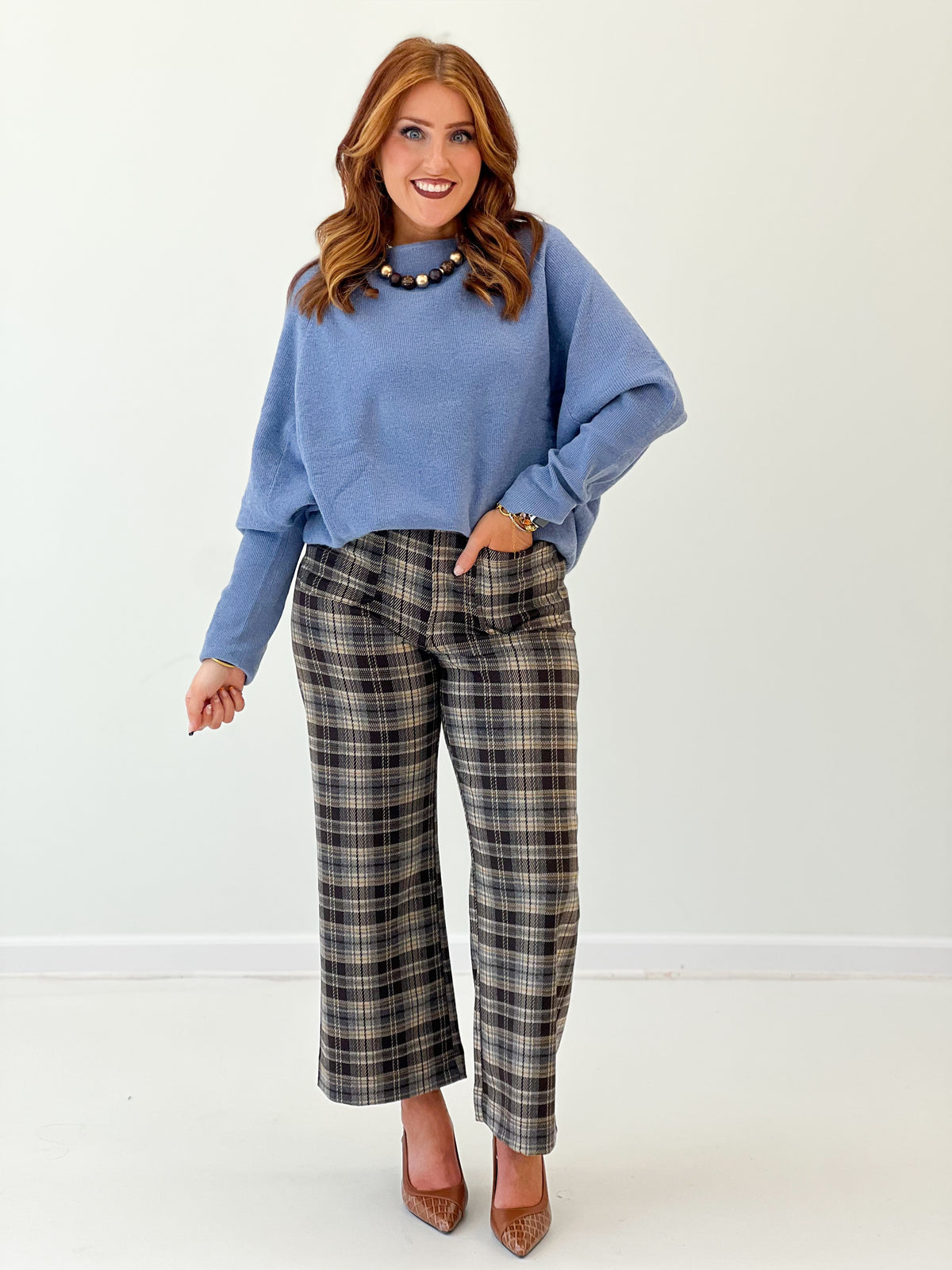Blue boat-neck knit sweater top with long sleeves and relaxed fit