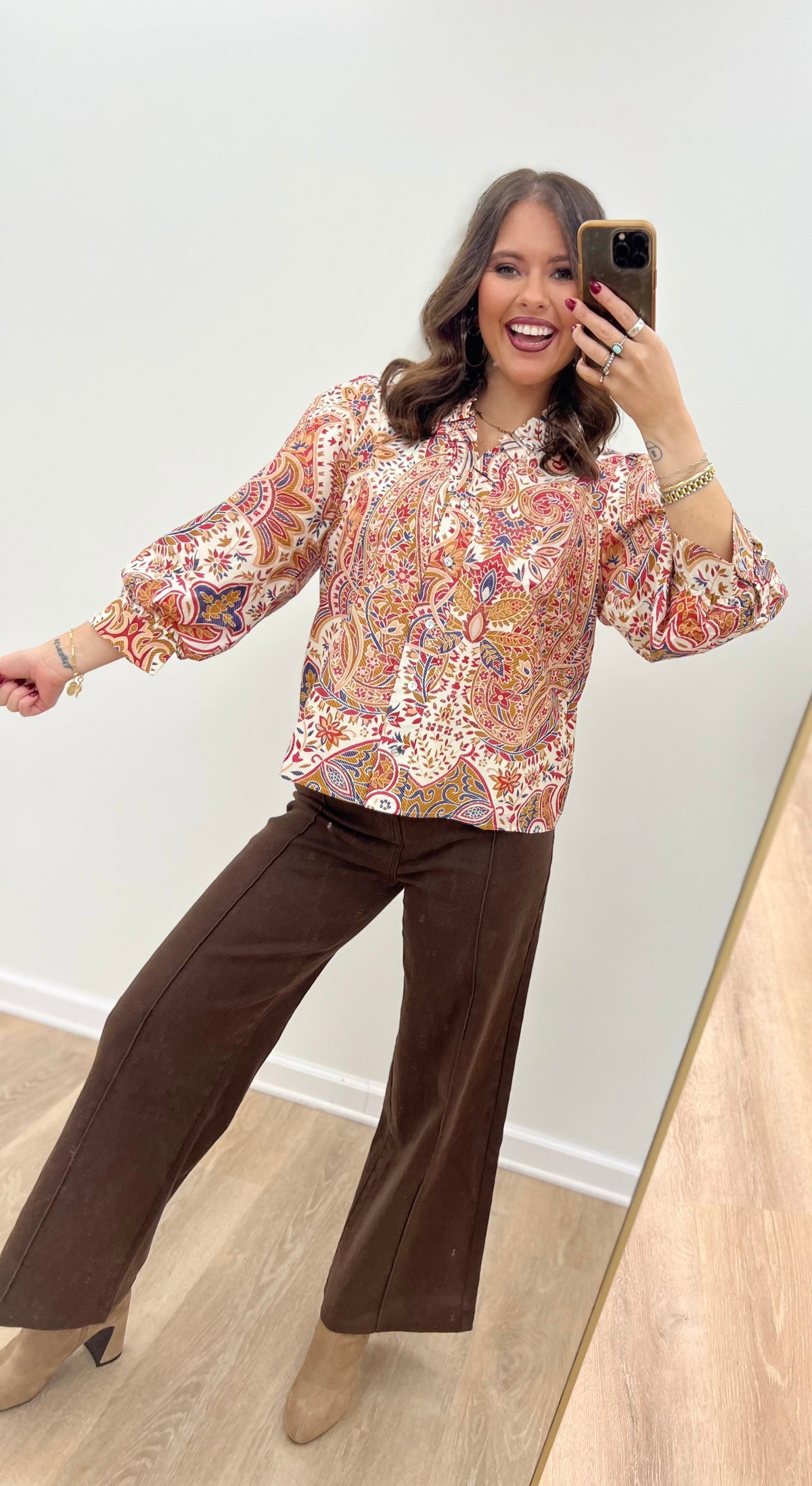 Cream floral button-down blouse with ruffled neck and long puff sleeves