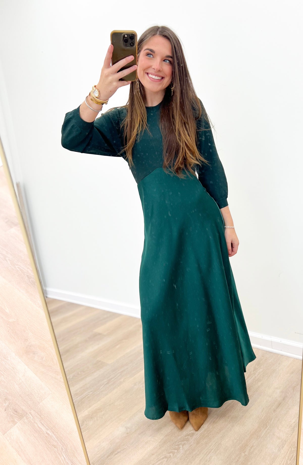 Dark green long-sleeve sweater dress with crew neck, maxi length, and flowing skirt