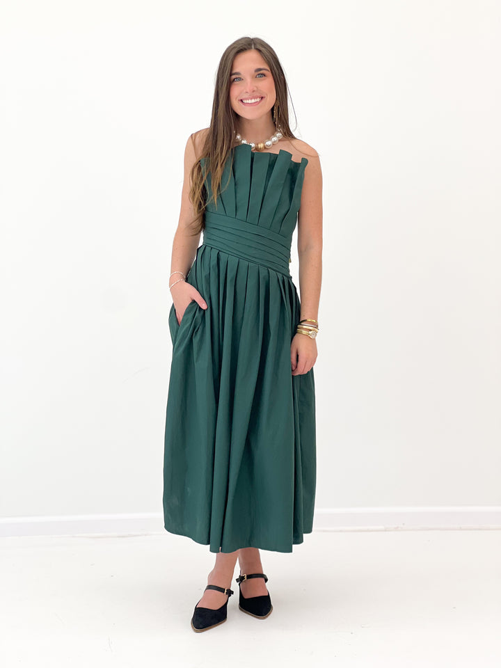 Hunter green strapless midi dress with vertical seams and pleated skirt