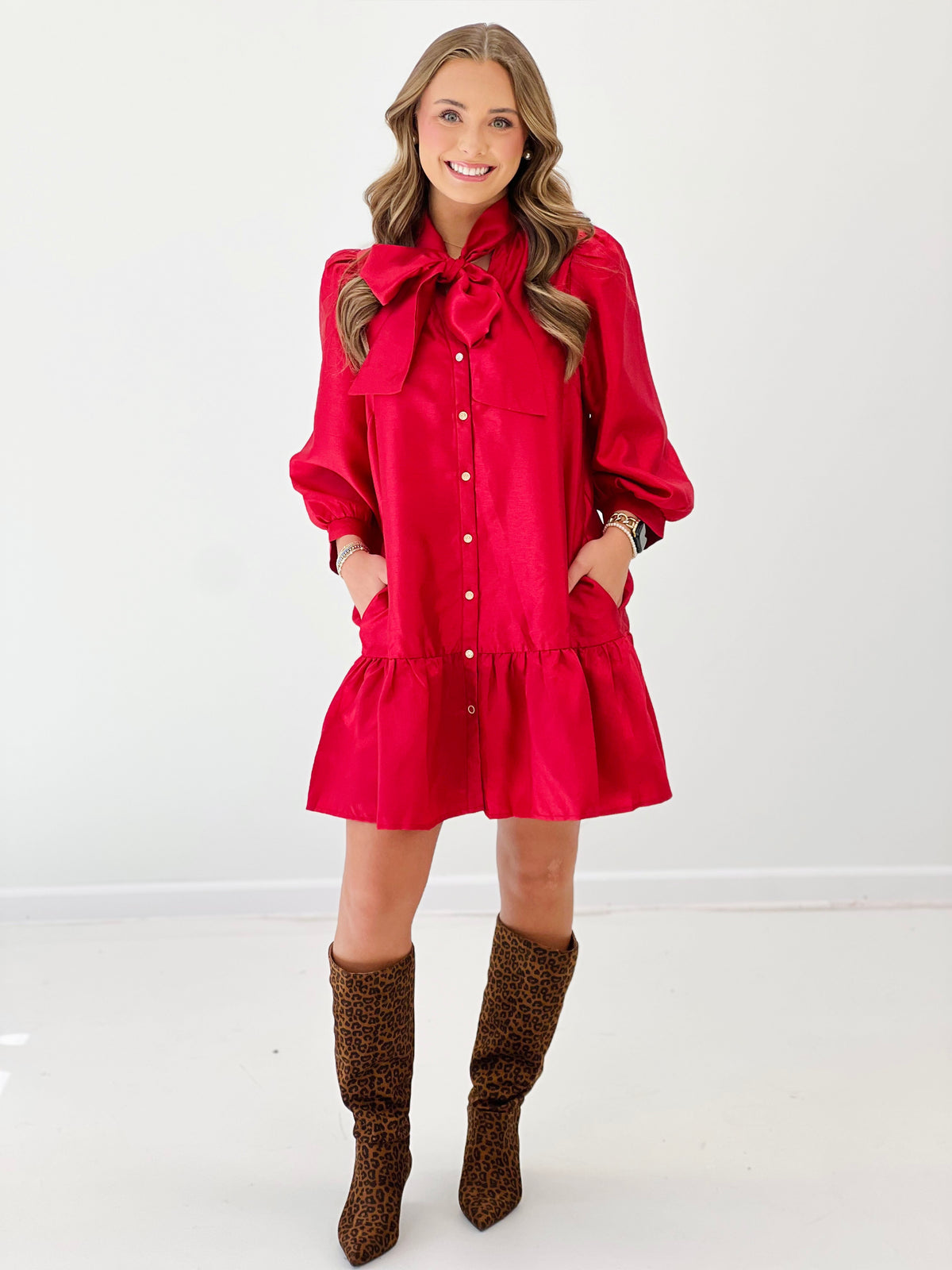 Red mini dress with bow neck, button front, balloon sleeves, tiered hem