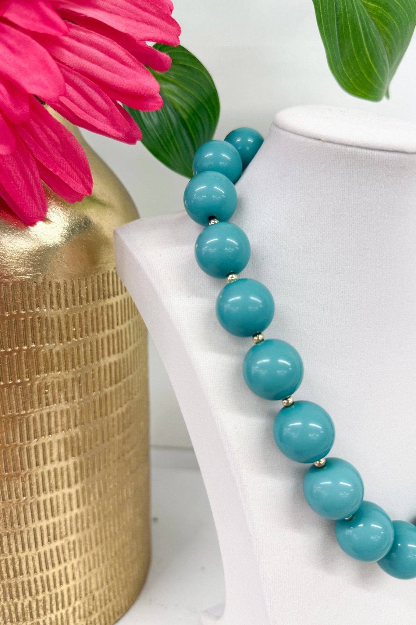 Acrylic ball chain necklace with a gold-tone finish