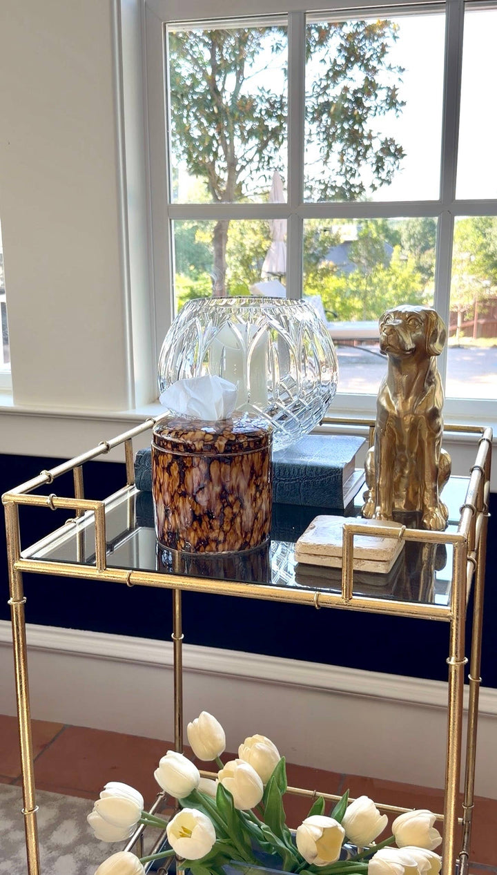 Decorative tissue vessel with white tissues in a dark marbled cylinder form