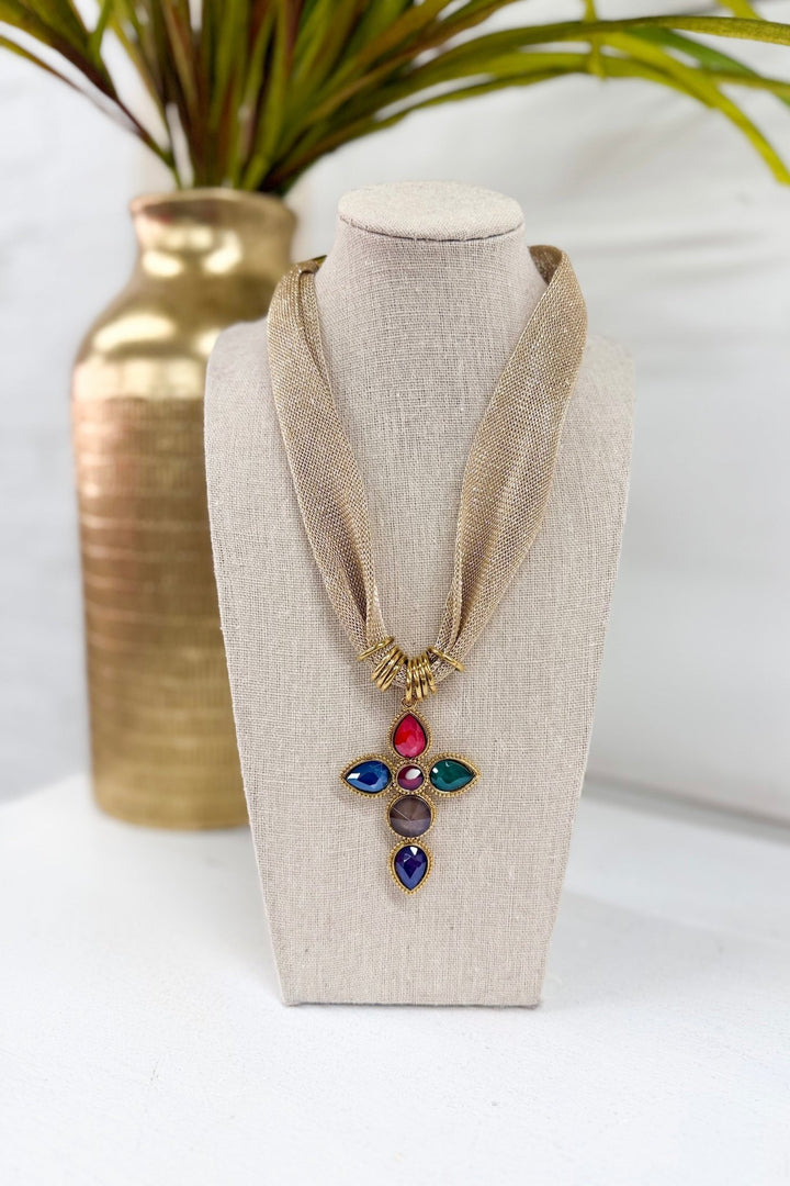 Gold cross pendant necklace on a fine chain