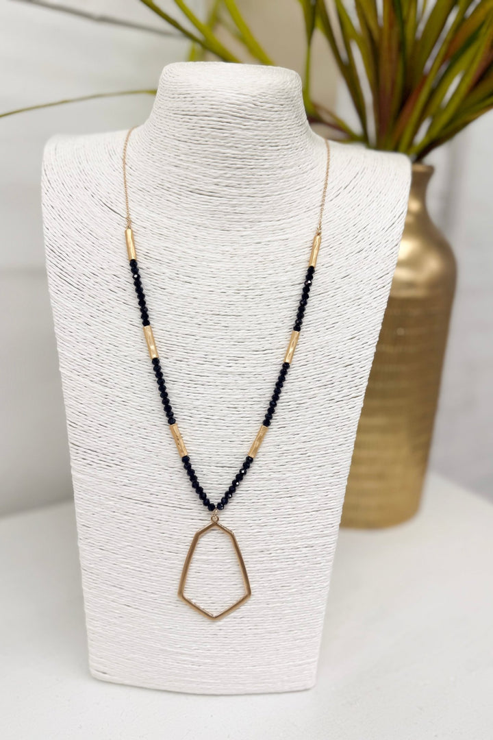 Black beaded necklace with a hexagon pendant
