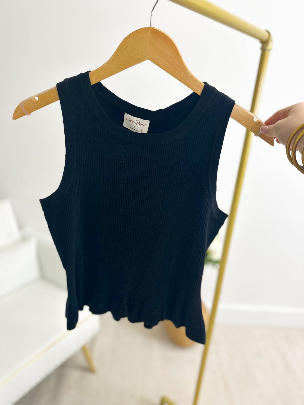 Sleeveless black peplum top with a fitted bodice