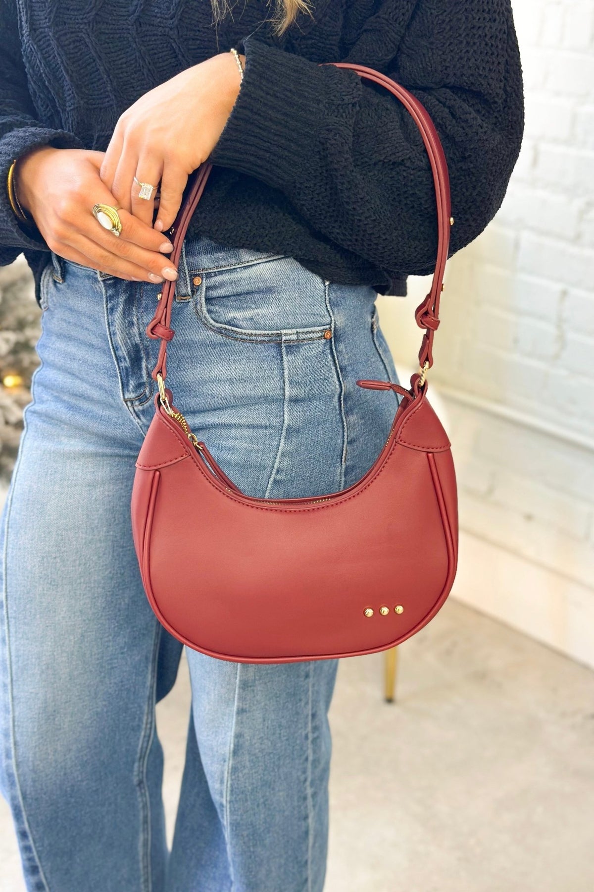 Burgundy crescent-shaped shoulder bag