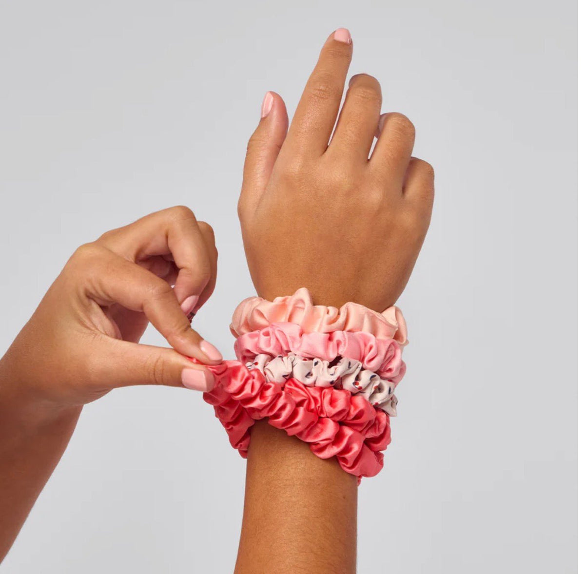 Five ruched satin scrunchies in cherry blossom shades