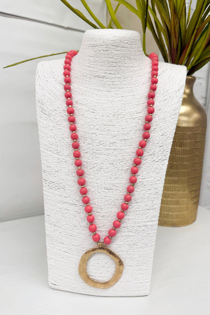 Coral beaded necklace with a circle pendant