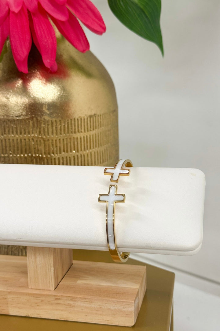 Cream and gold bangle bracelet with a cross accent
