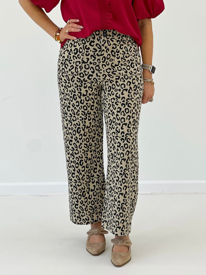 Taupe leopard print pants with an exposed front zipper