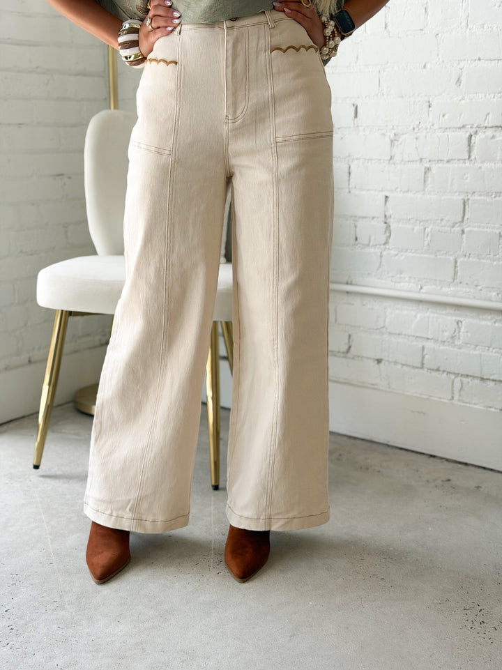 Ecru pants with scalloped edge front pockets