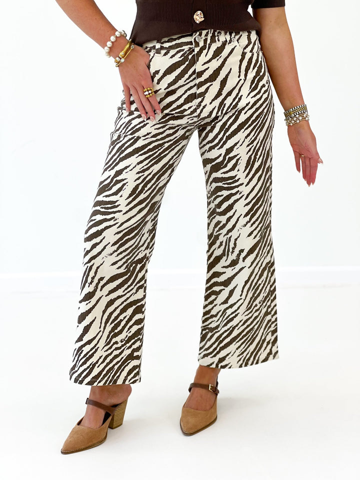Zebra-print wide-leg pants in ecru with black pattern, ankle length.
