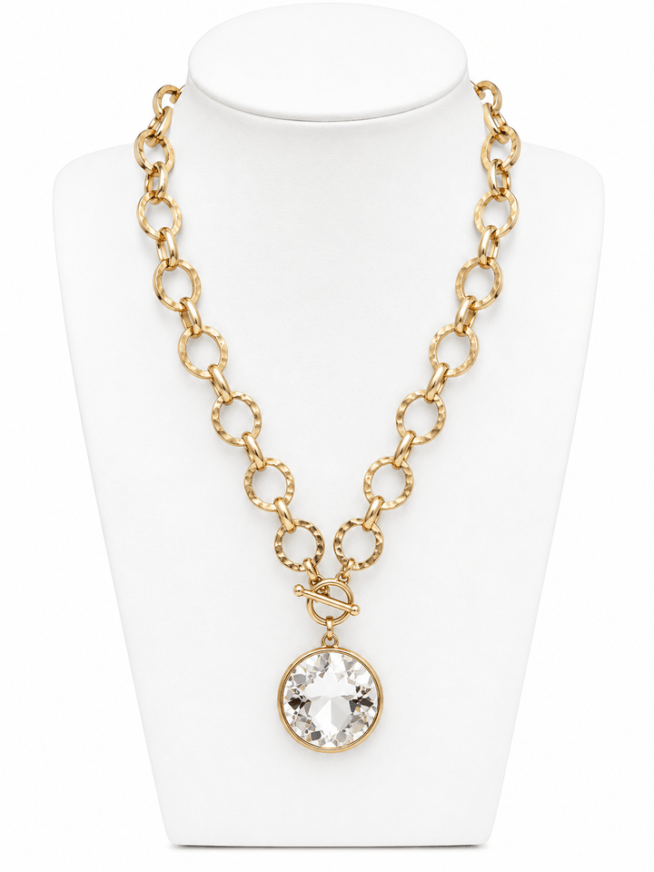 Round glass pendant on a gold chain necklace