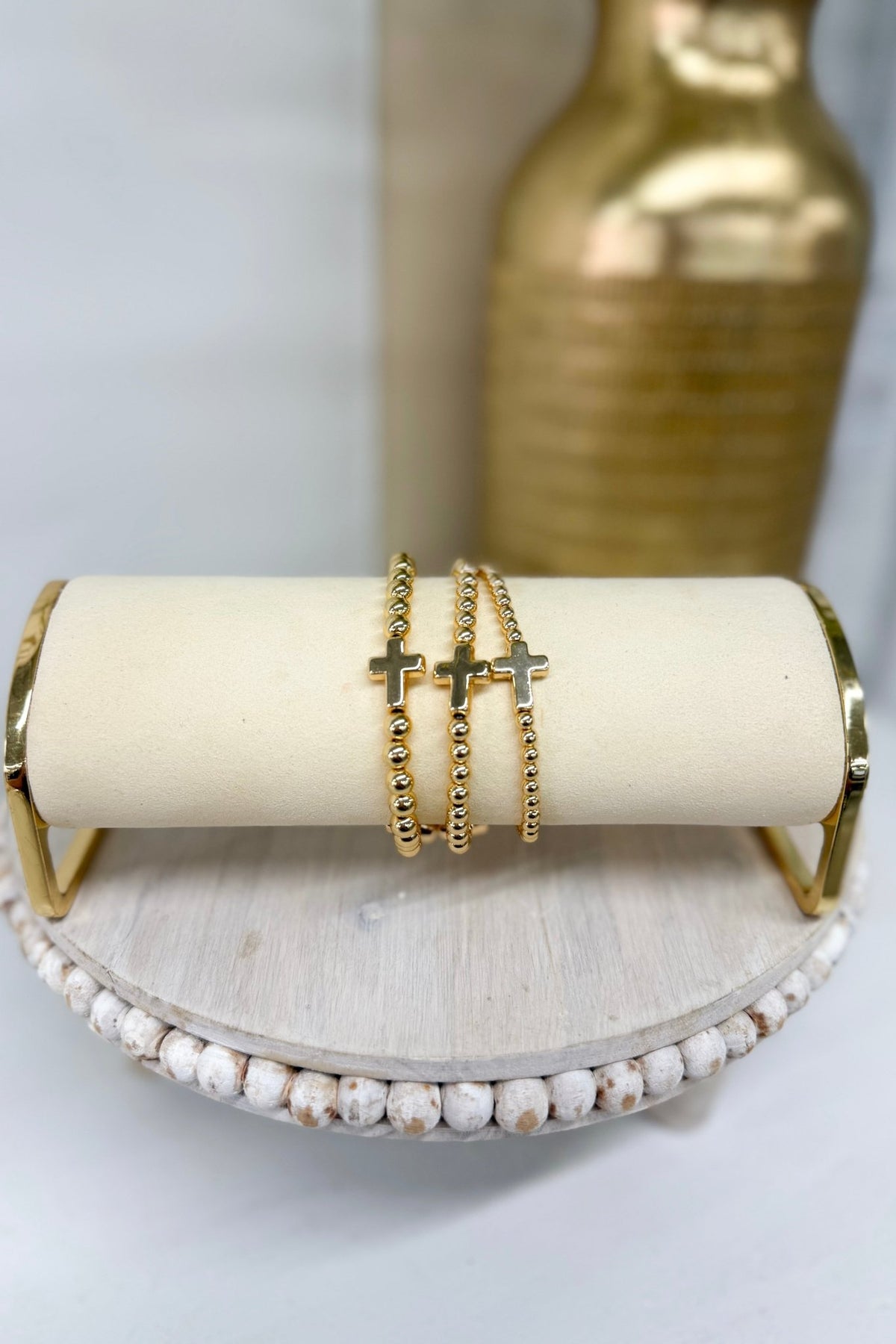 Three-row gold ball bracelet with a cross charm