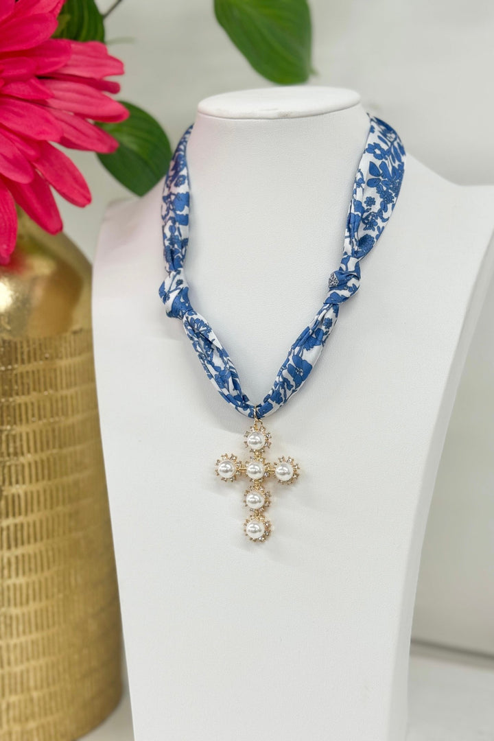 Gold and blue pearl necklace with a cross charm