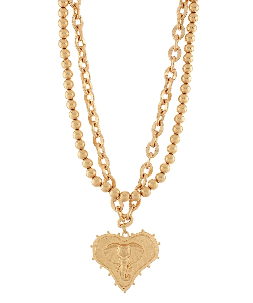 Mascot and heart pendants on layered worn gold chains