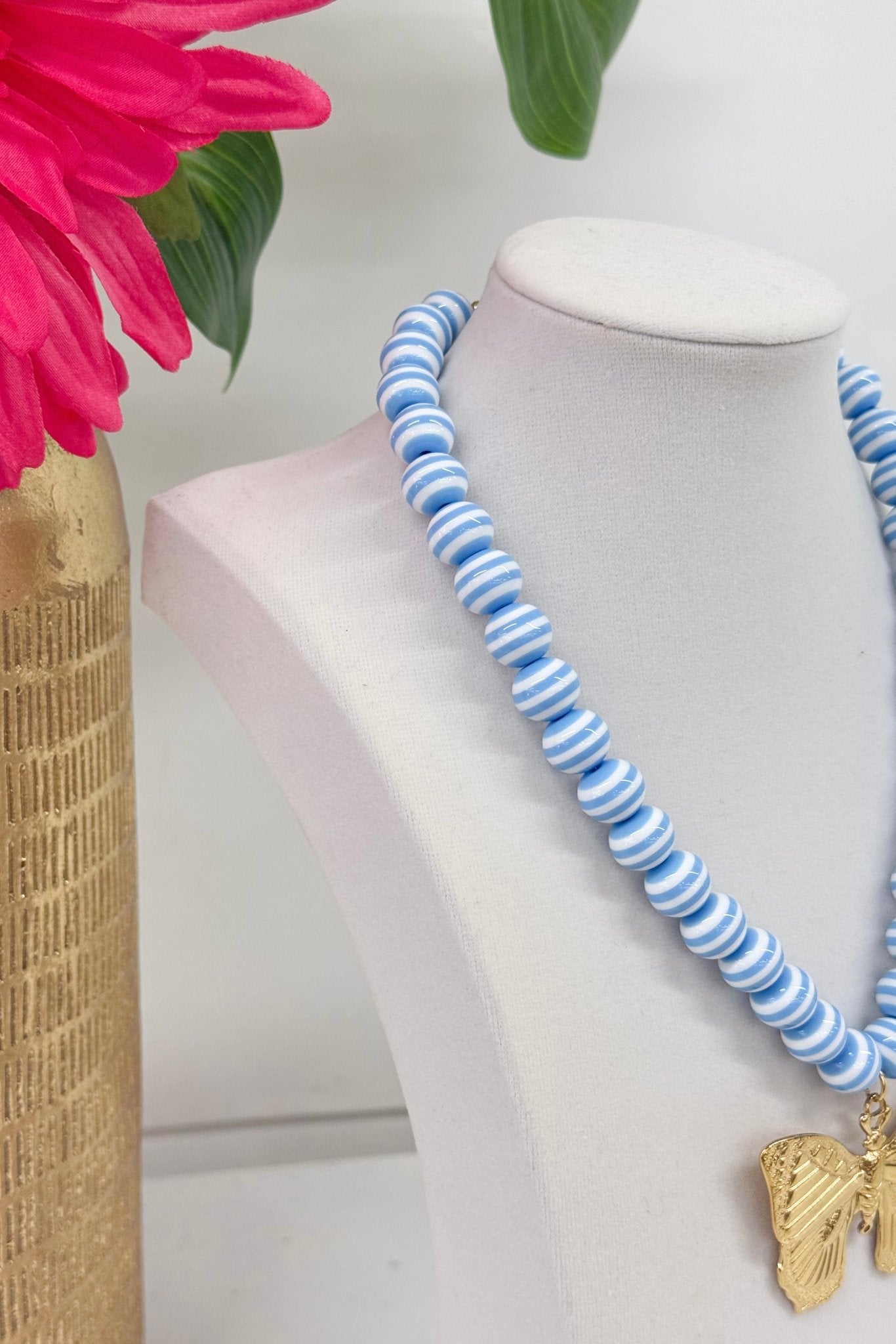 Butterfly charm on a blue and white beaded strand