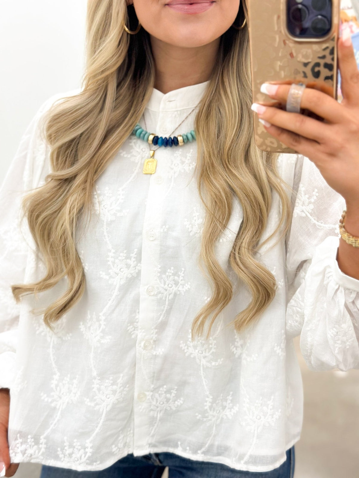 Off white button down top with a pointed collar