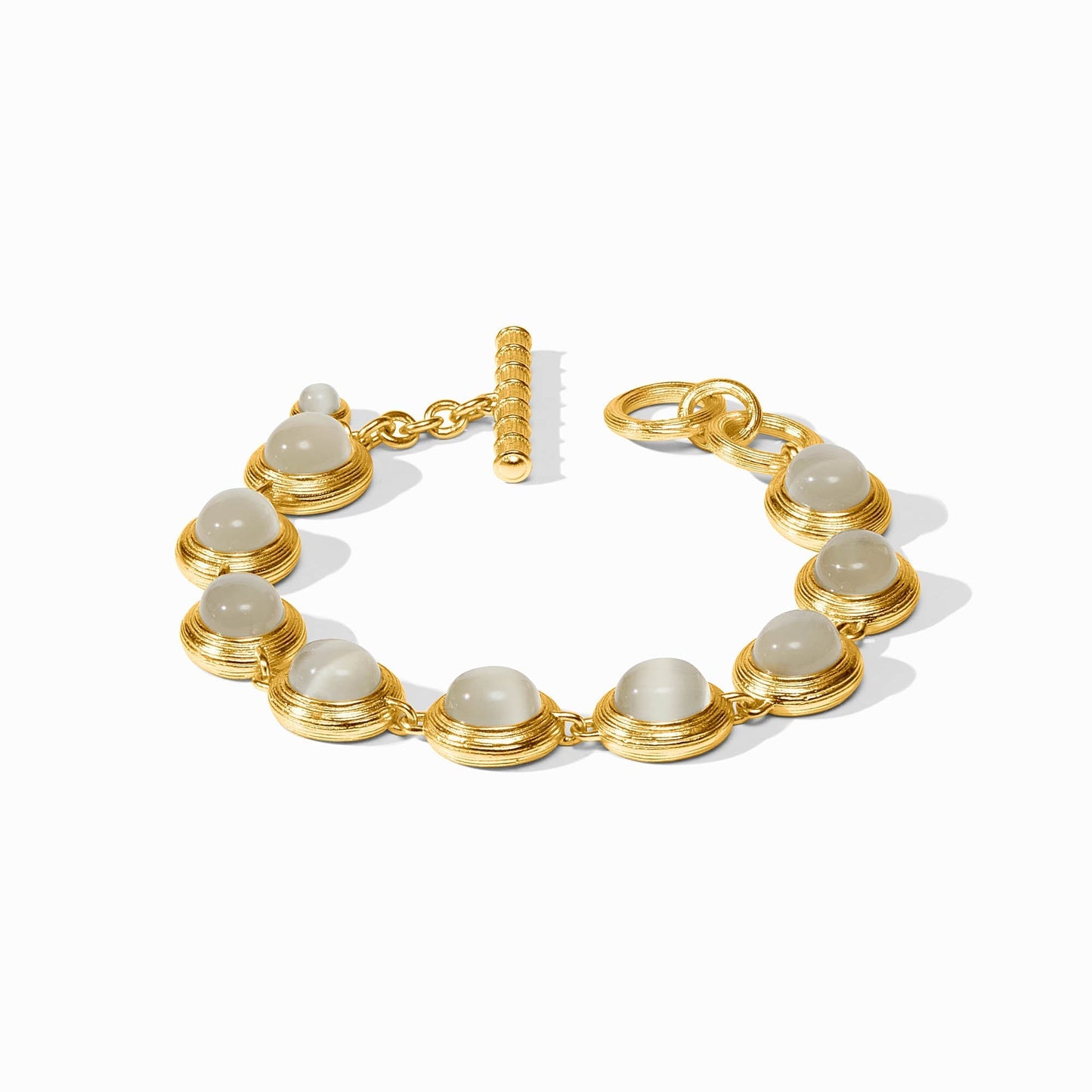 Gold tennis bracelet lined with ivory cat's eye stones