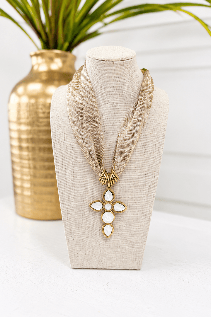 Gold necklace with a small cross pendant