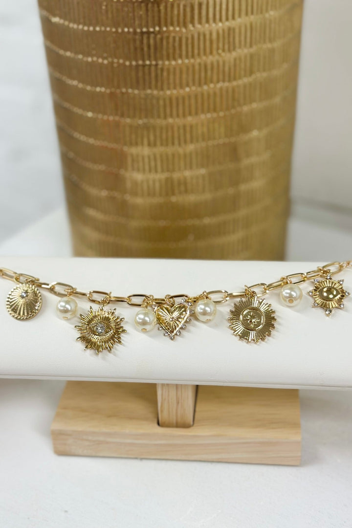 Gold textured bracelet with multiple heart charms
