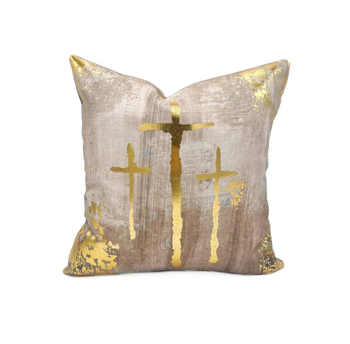 Neutral velvet throw pillow with golden cross motifs