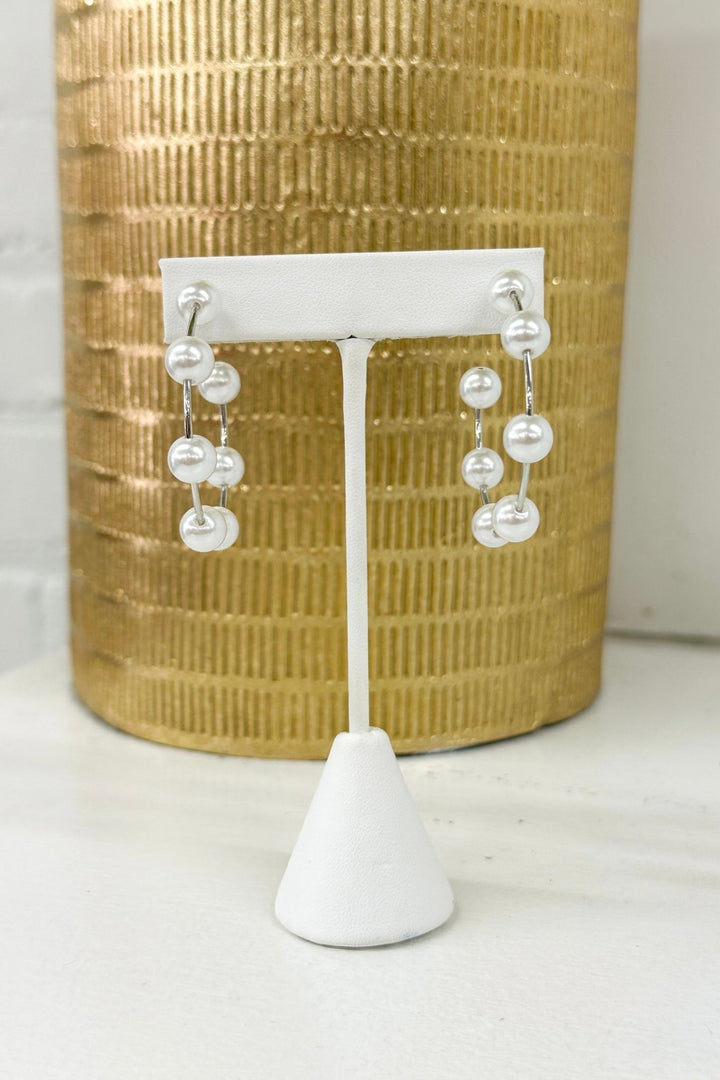 Open hoop earrings with a pearl accent