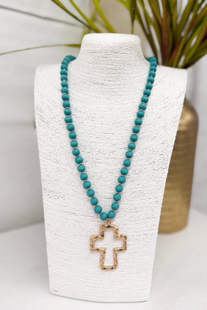 Wood bead necklace with a turquoise cross pendant