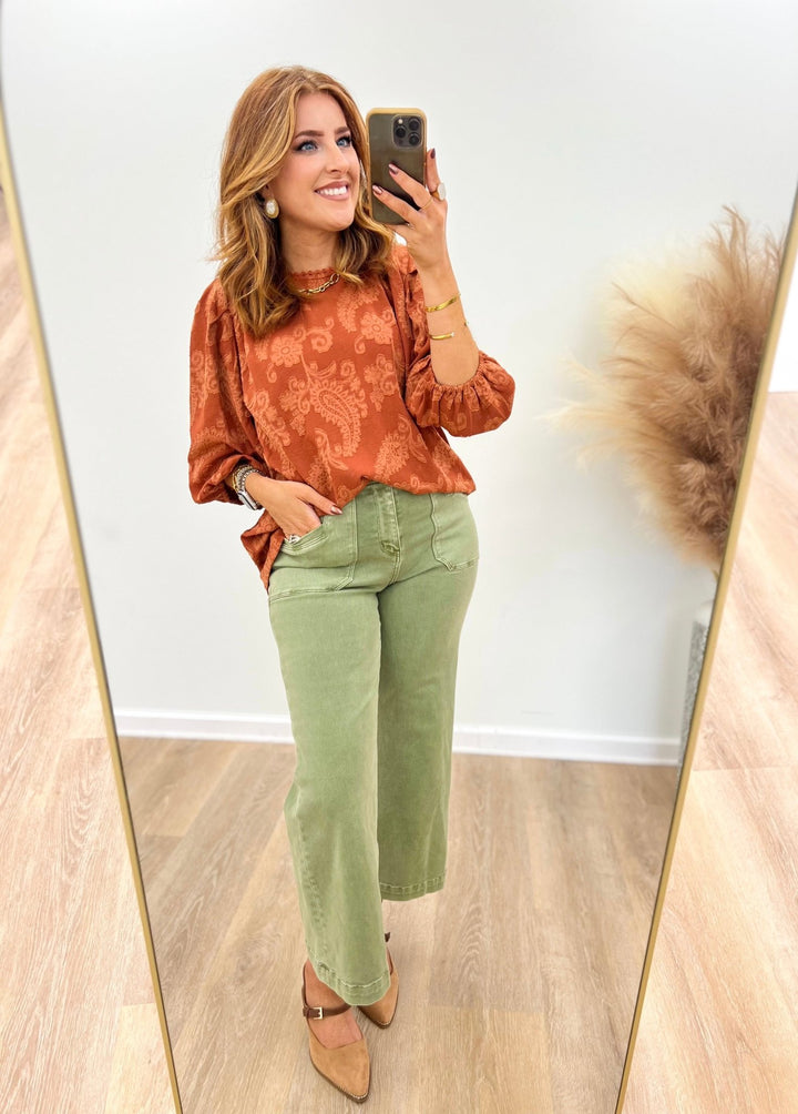Terracotta lace detail puff sleeve blouse with round neckline and textured pattern