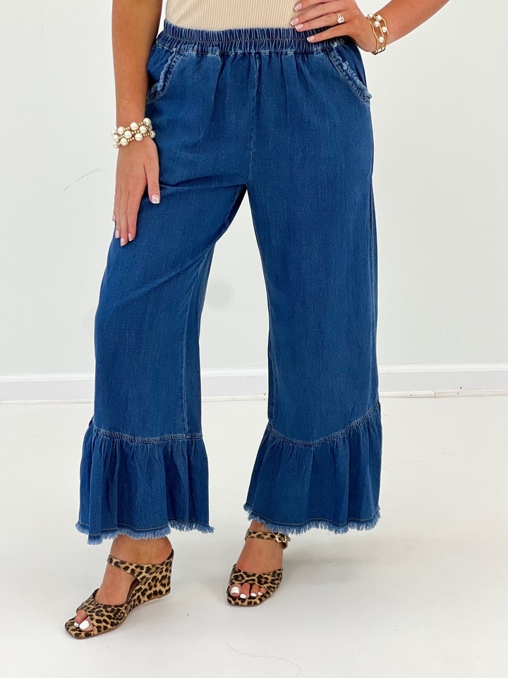 Denim pants with a tiered ruffle hem