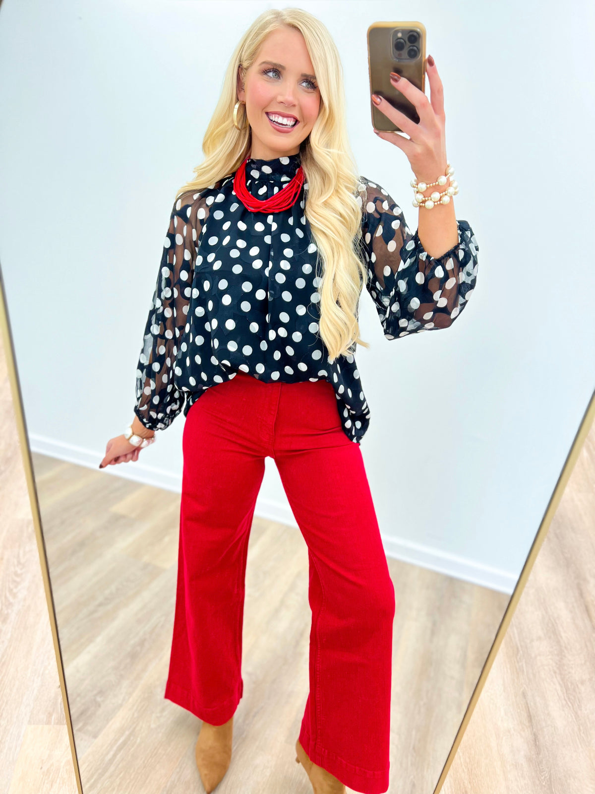 Black polka dot high-neck long-sleeve blouse with red contrast collar